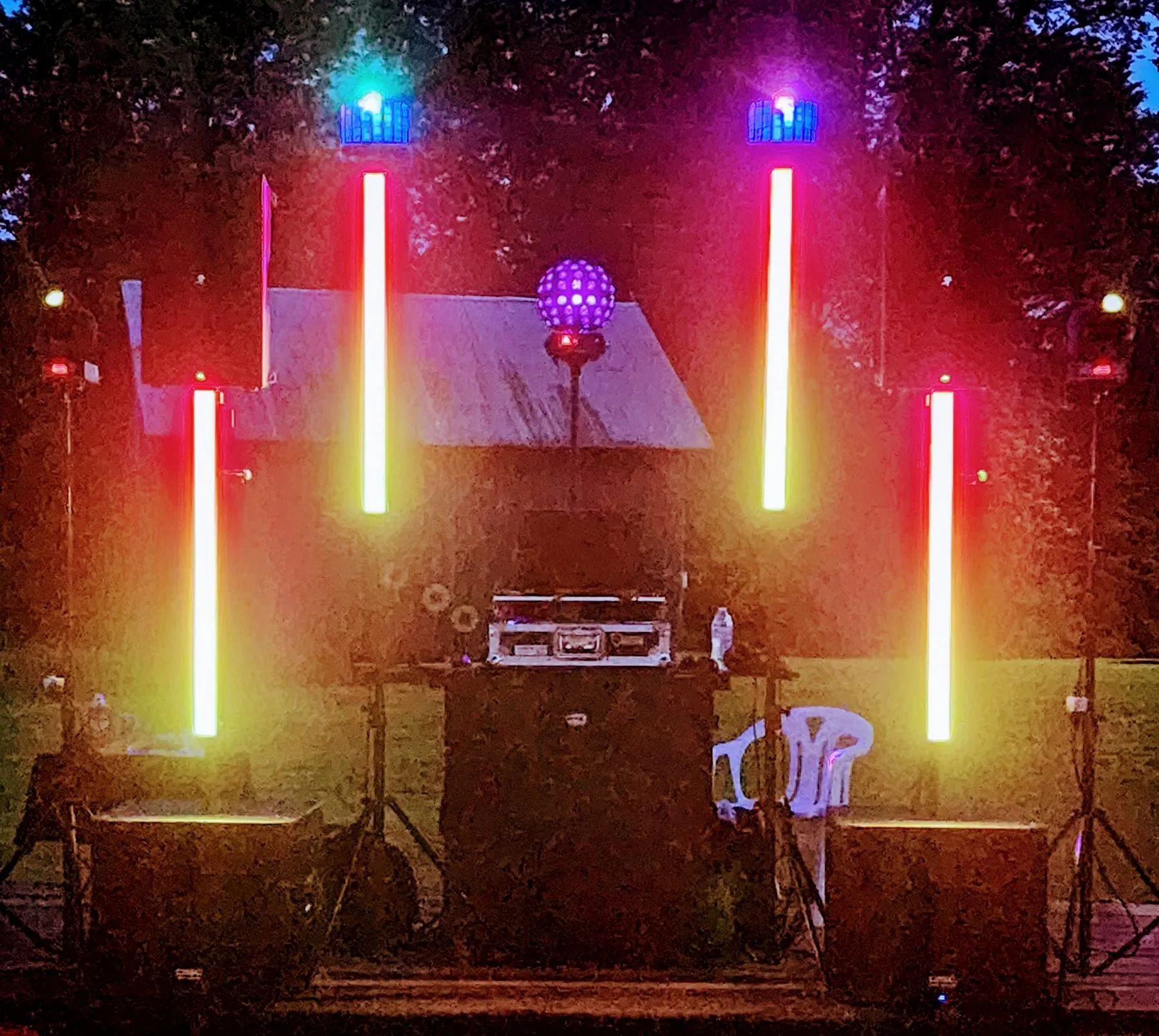 Outdoor stage lit with colored LED tubes at night
